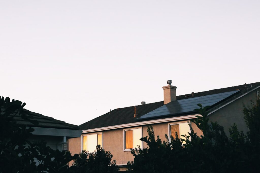 A contemporary house featuring rooftop solar panels, demonstrating the benefits of solar energy and sustainable power solutions.