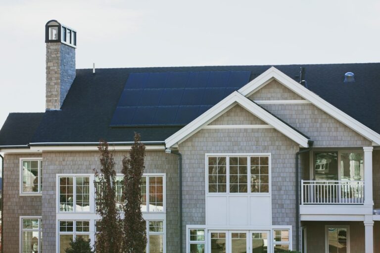 An image of a nice looking home with solar panels on roof.